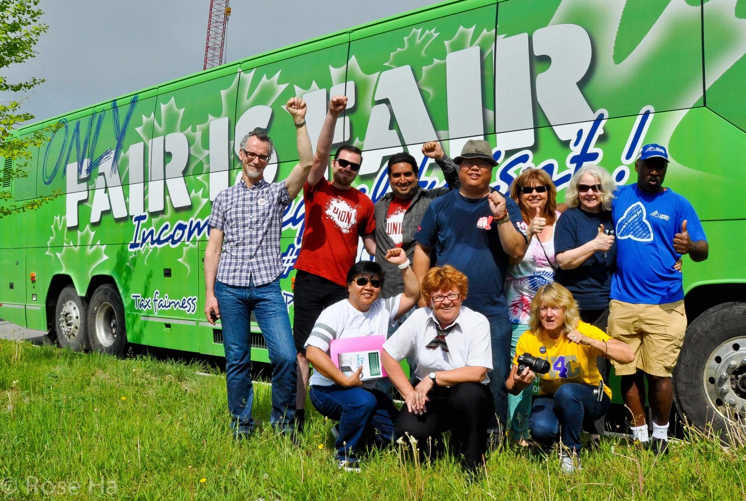 OPSEU members posing in front of the bus that says: Only fair is fair.
