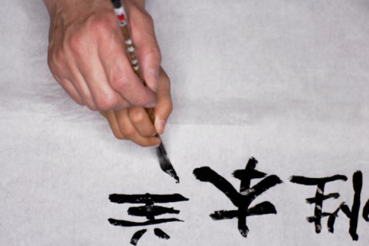 Adult teaching child to write Chinese characters